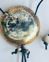 Round smoke fired pendant with gold.