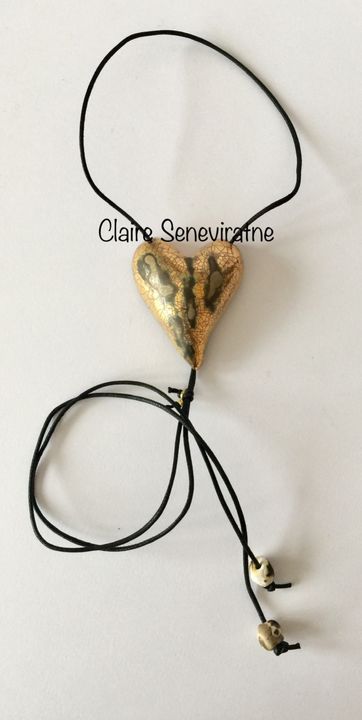 Large gold heart pendant with crackled textures.