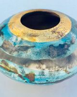 Blue and gold pit-fired vessel.