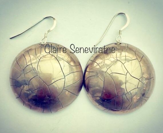 Large round silver earrings.