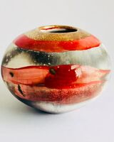 Red smoke-fired pot with gold lustre.