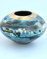 Blue and gold pit-fired vessel.