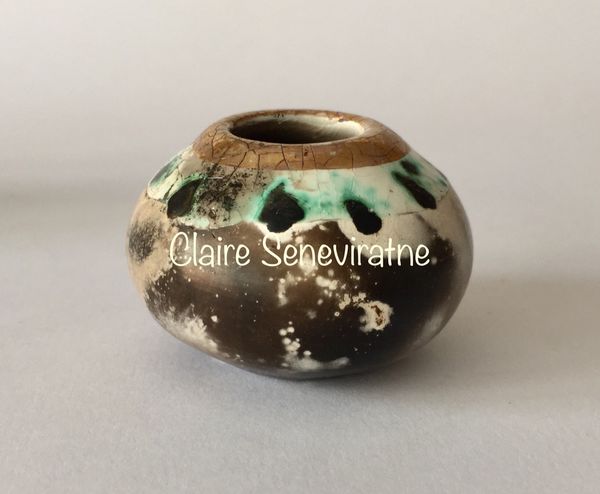 Small smoke fired pot with gold.