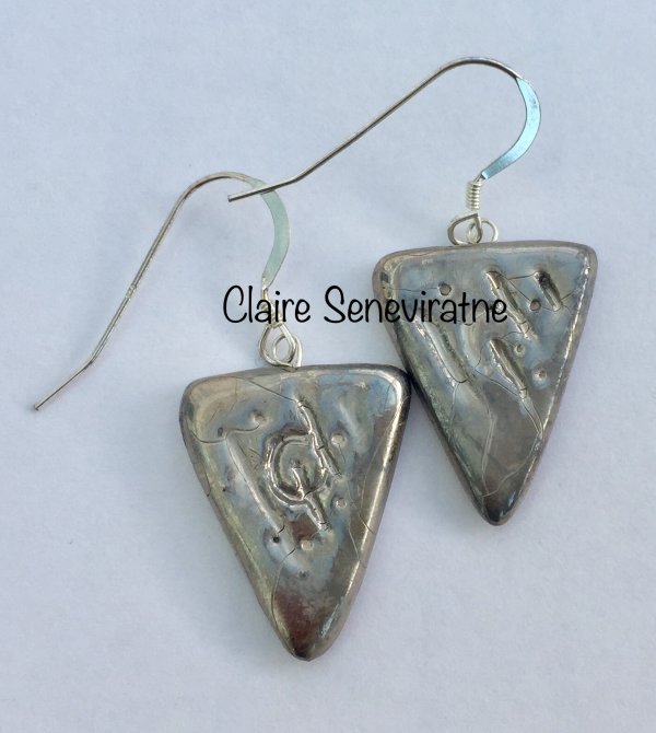 Silver triangle earrings.