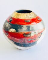 Red smoke-fired pot with gold lustre.