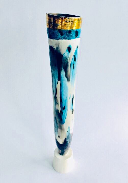 Tall blue smoke-fired vessel on a stand.