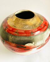 Red smoke-fired pot with gold lustre.