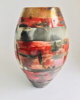 Large red smoke-fired pot with gold lustre.