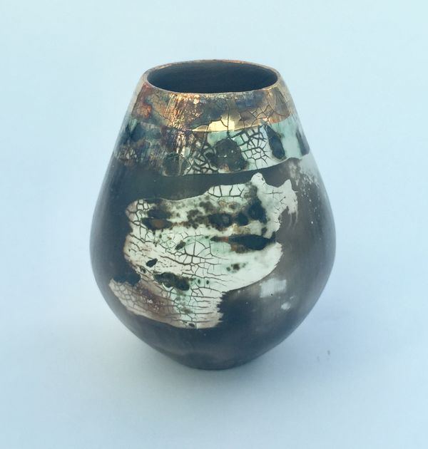 Sawdust fired ceramic pot with partial glaze and gold lustre.