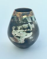 Sawdust fired ceramic pot with partial glaze and gold lustre.