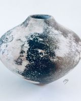 Ceramic pot with black and white.
