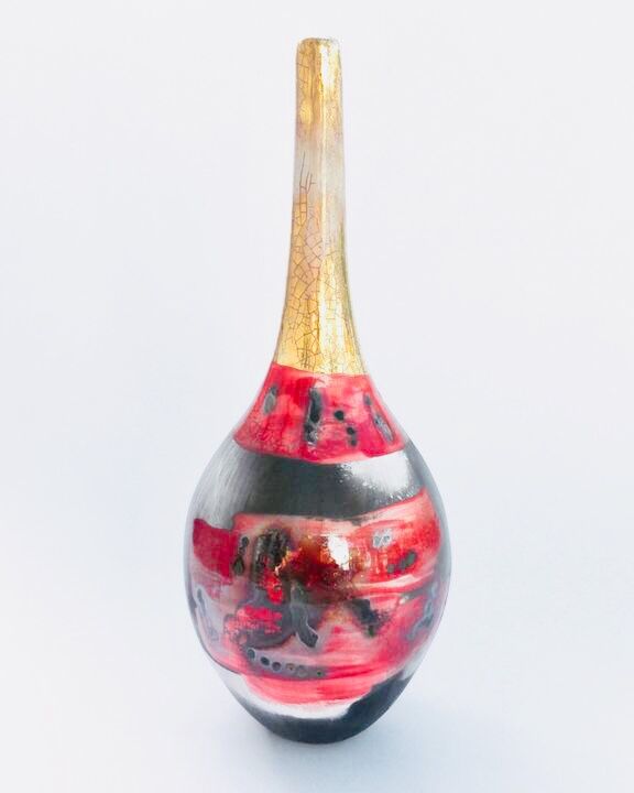 Red smoke-fired pot with gold lustre.