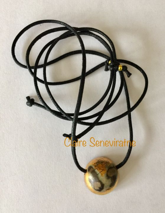 Raku style ceramic pendant.