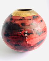 Red smoke-fired pot with gold lustre.