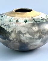 Large smoke-fired ceramic pot with gold lustre.