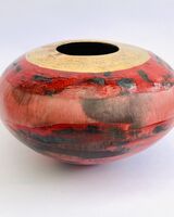 Red smoke-fired pot with gold lustre.