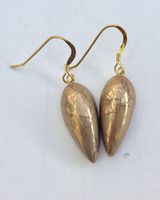 Gold teardrop earrings.