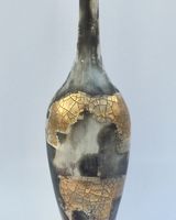 Smoke fired pot with long neck.