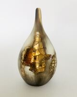 Smoked-fired pot with gold lustre.