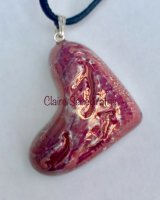Pink heart pendant hung on its side.