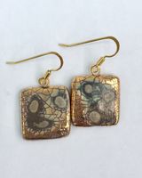 Square gold drop earrings.