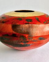 Red smoke-fired pot with gold lustre.