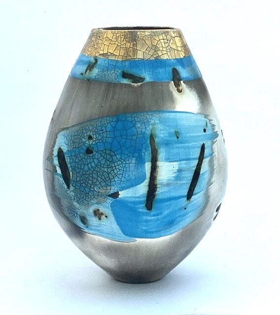 Blue smoke-fired ceramic pot with glaze and gold lustre.