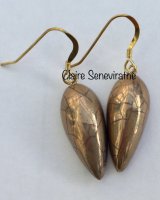 Gold teardrop earrings.