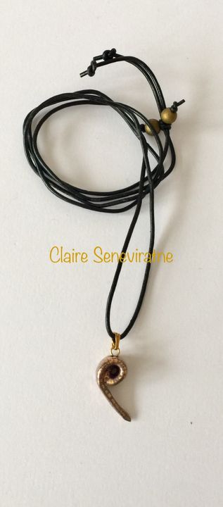 Gold spiral ceramic pendant.
