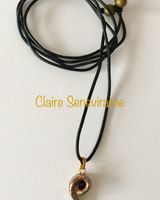 Gold spiral ceramic pendant.