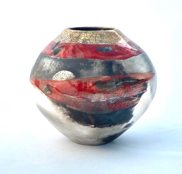 Red smoke-fired pot with gold lustre.