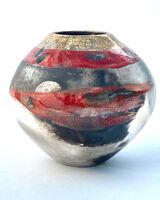 Red smoke-fired pot with gold lustre.