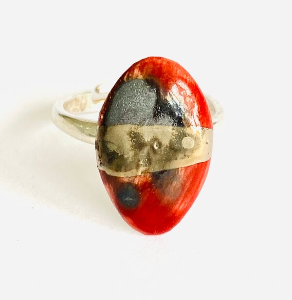 Red porcelain ring mounted on to a sterling silver band.