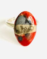 Red porcelain ring mounted on to a sterling silver band.
