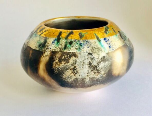 Burnished smoke-fired ceramic pot with gold lustre.