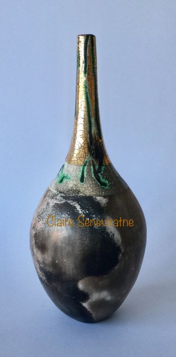 Smoke fired pot with long neck and gold lustre.