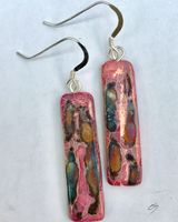Pink rectangular ceramic earrings with iridescent colours.