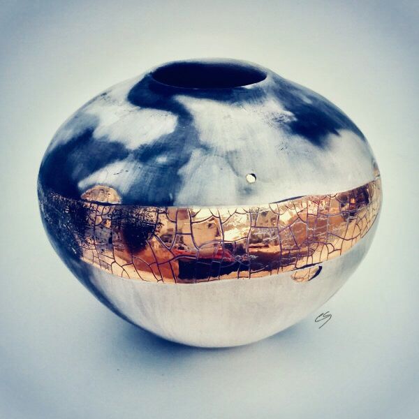 Small ceramic pot with gold lustre.