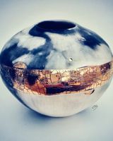 Small ceramic pot with gold lustre.