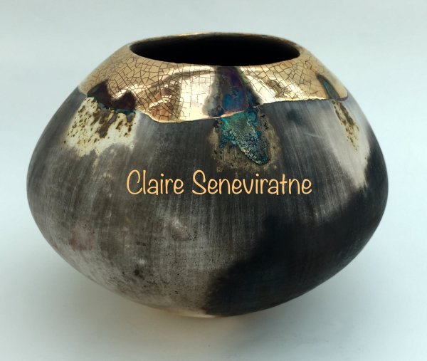 Ceramic smoke fired pot with gold and copper.