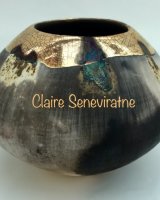Ceramic smoke fired pot with gold and copper.