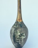 Elegant sawdust fired pot with gold lustre.