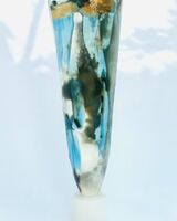 Large blue smoke-fired pot on stand with gold lustre.
