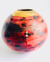 Red smoke-fired pot with gold lustre.