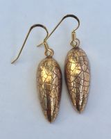 Gold ceramic teardrop earrings.