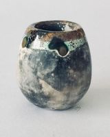 Tiny upright smoke fired pot.