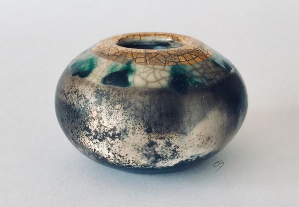 Small smoke fired pot with gold.