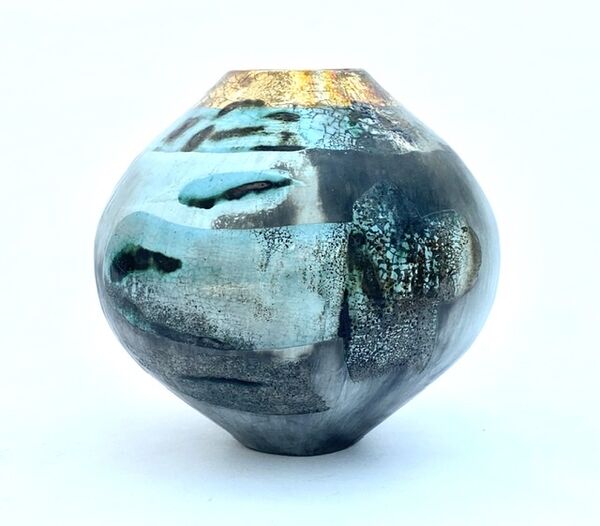 Blue smoke-fired ceramic pot with glaze and gold lustre.