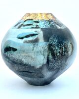 Blue smoke-fired ceramic pot with glaze and gold lustre.