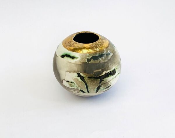 Burnished smoke-fired ceramic pot with gold lustre.